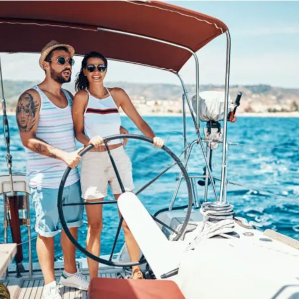 Young couple jet skiing on the open sea. They are smiling and enjoying summer sport on water.
